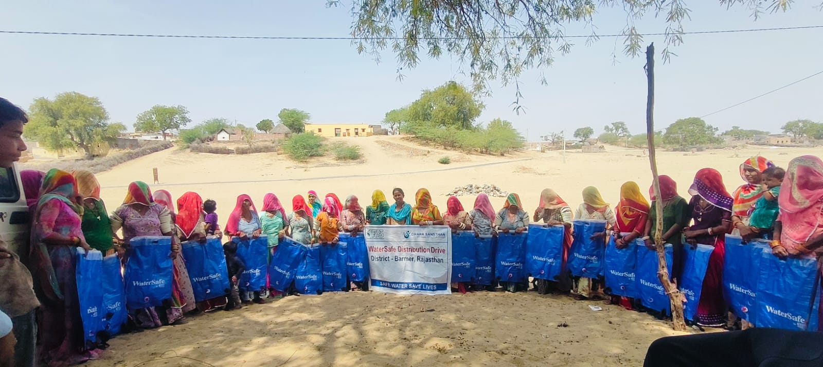 A group of people in Barmer India carrying the WaterSafe backpacks.